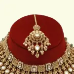 Heavy bridal brass choker necklace set with earrings and maang tikka in antique gold finish, Ishwar Arts and Crafts