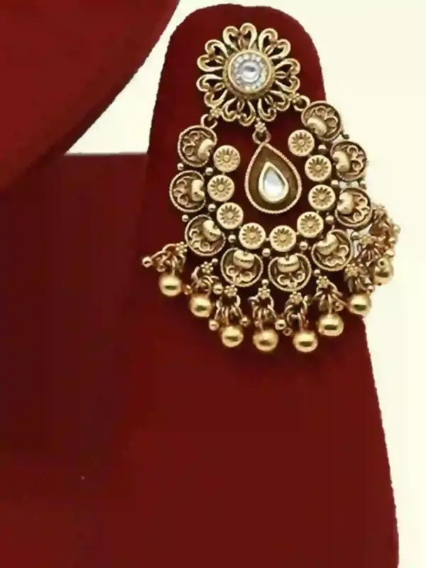 Antique gold brass bridal necklace set with Kundan stones, matching earrings, and maangtika on red display, Ishwar Arts and Crafts